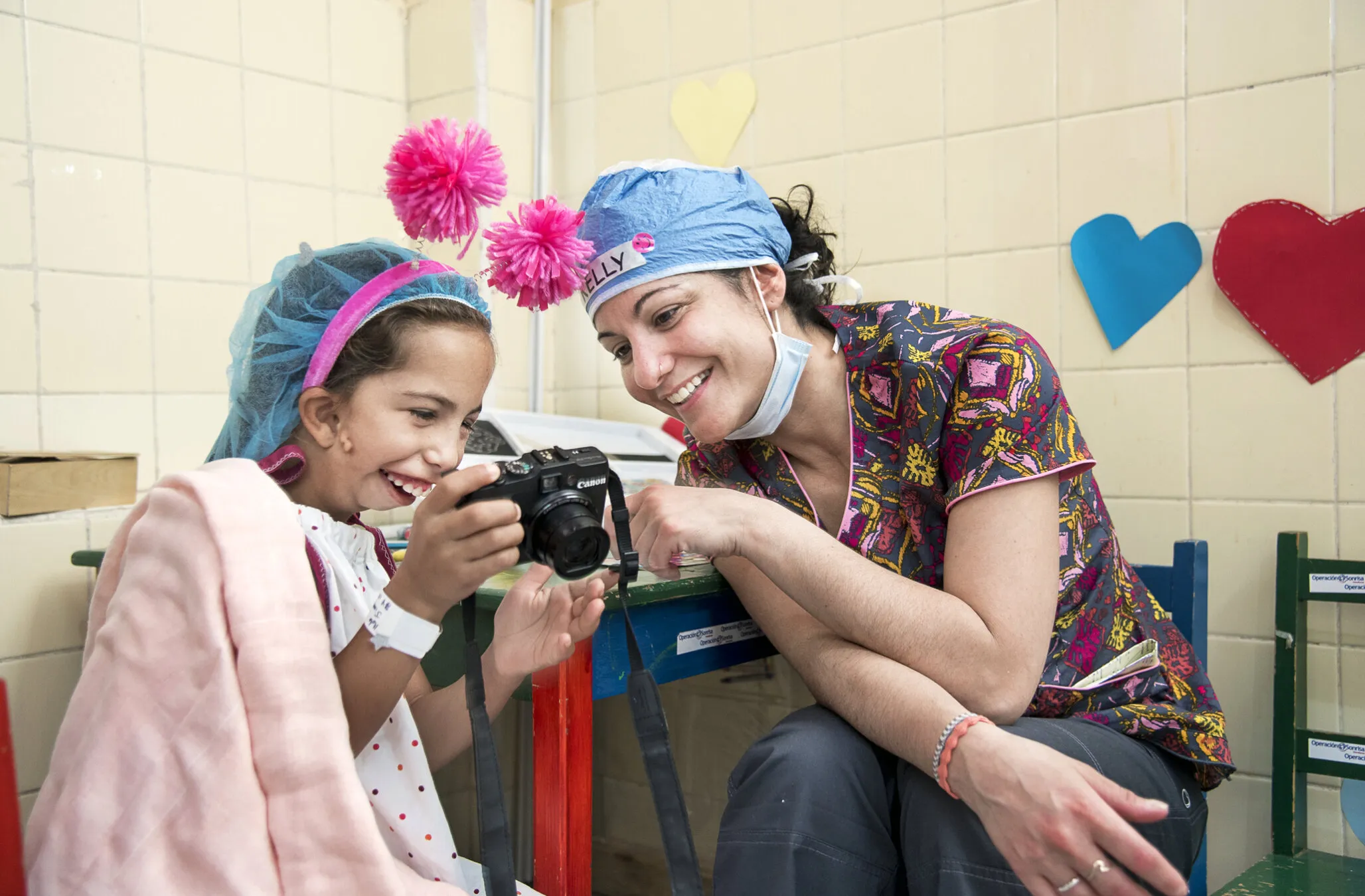 Operation Smile volunteer psychosocial care provider Kelly Raymond works with a young patient during a surgical program in Honduras.