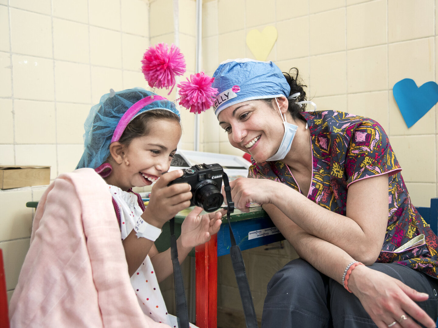 Operation Smile volunteer psychosocial care provider Kelly Raymond works with a young patient during a surgical program in Honduras.
