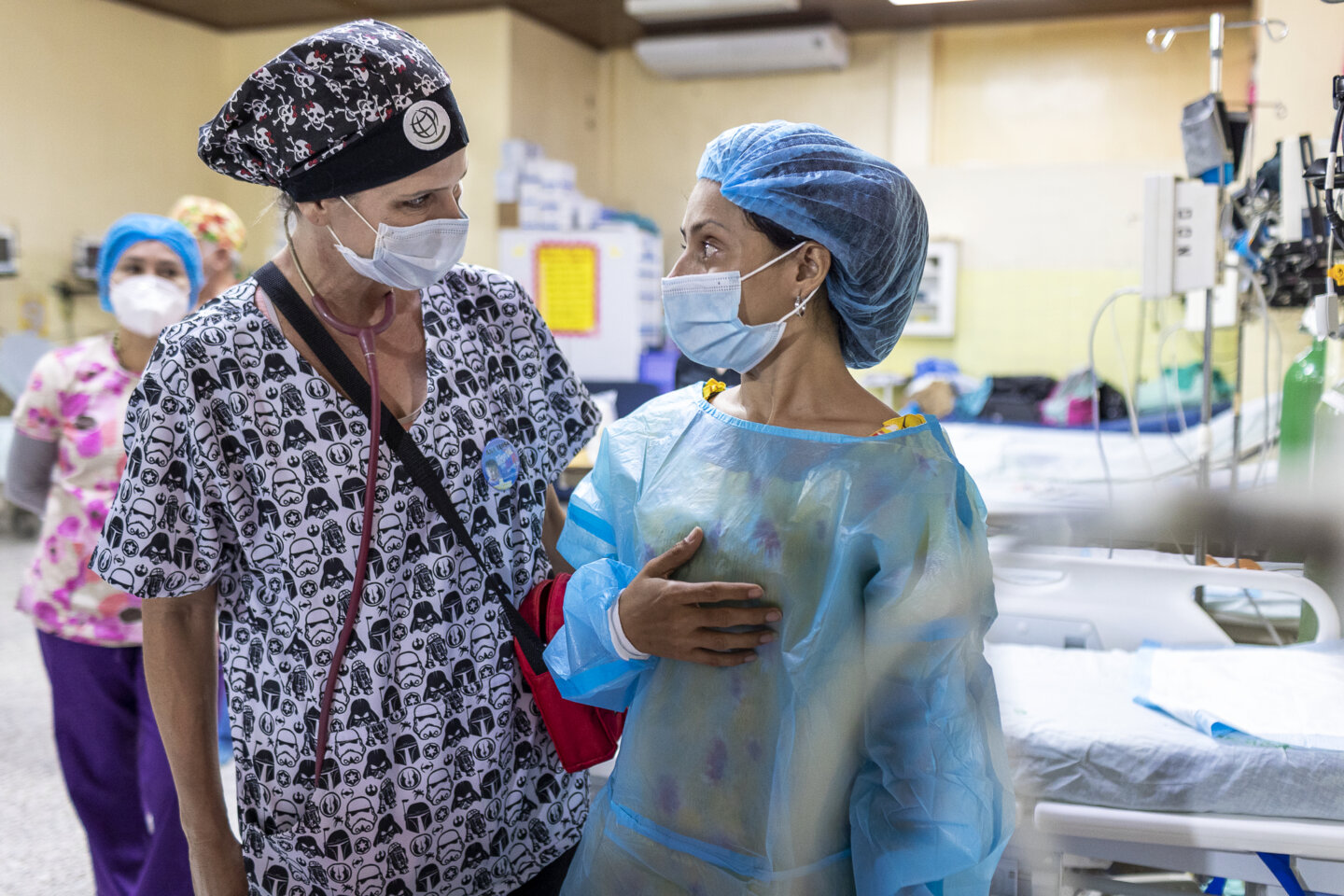 Ana, Zoe's mom, speaks with a volunteer at a surgical program in Tegucigalpa, Honduras.