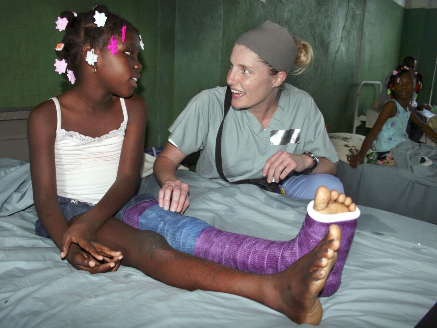 Nine-year-old Jessica speaks with an Operation Smile volunteer.