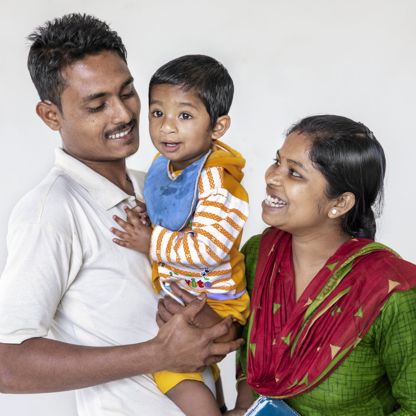A patient smiles with his parents.