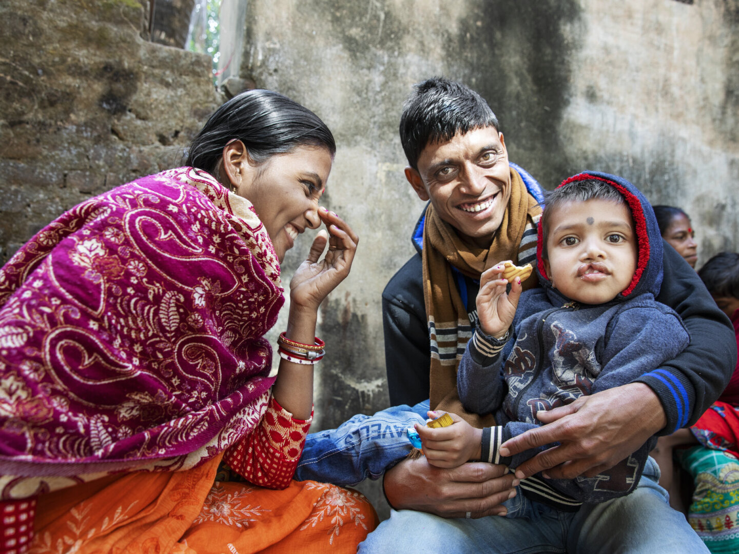 Shyam, before surgery, shares a snack with his parents.