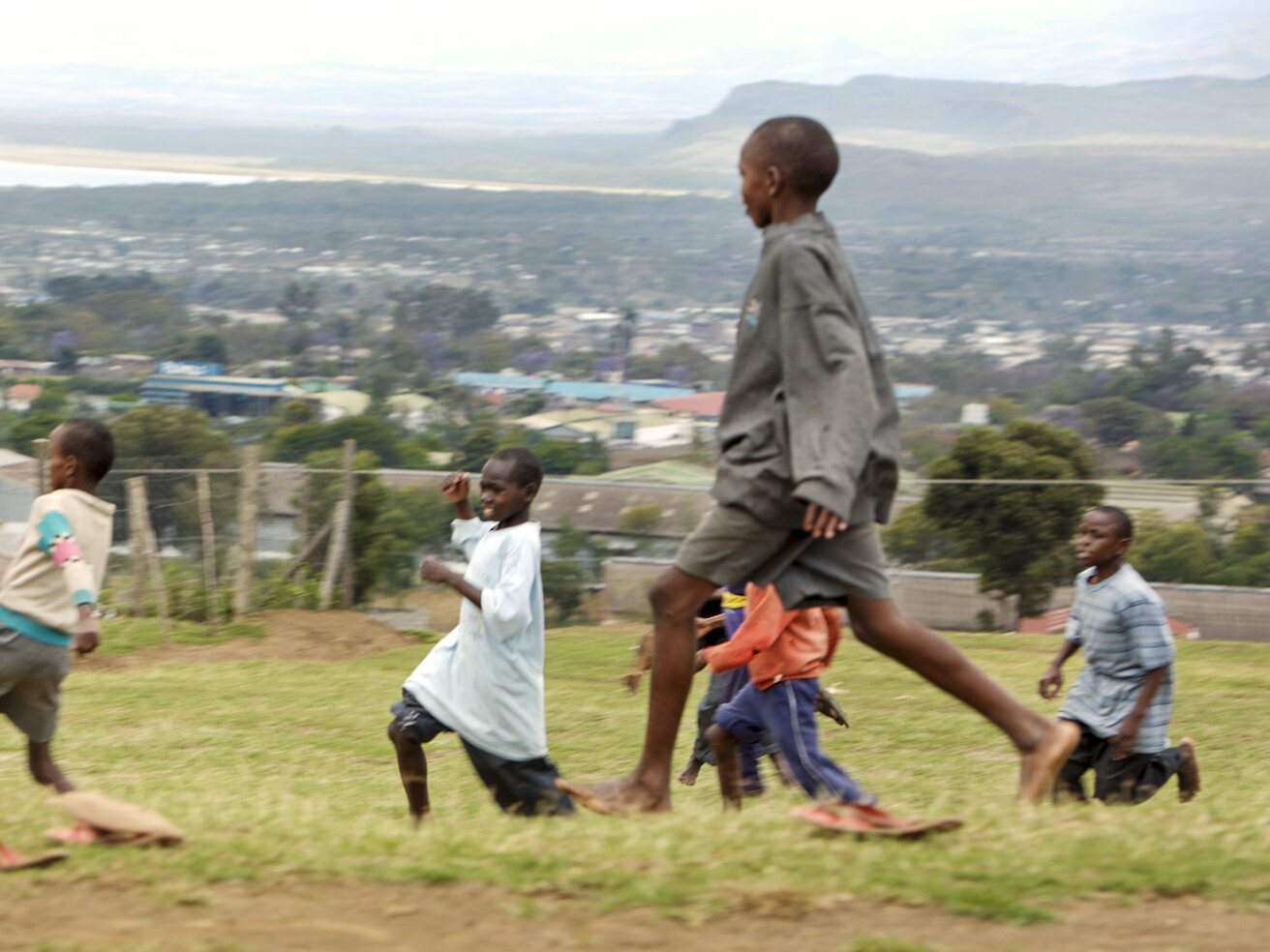 Children play soccer in Kenya.
