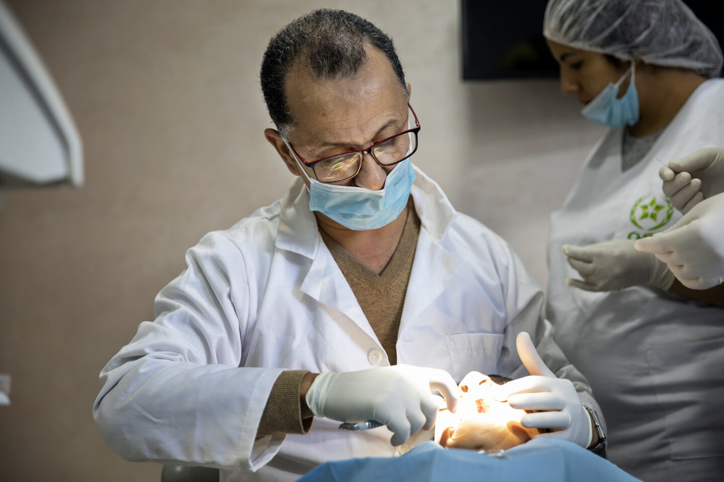 Dr. Lahcen Oussehal, Operation Smile Morocco volunteer orthodontist, examines a patient at the care center in Casablanca, Morocco.