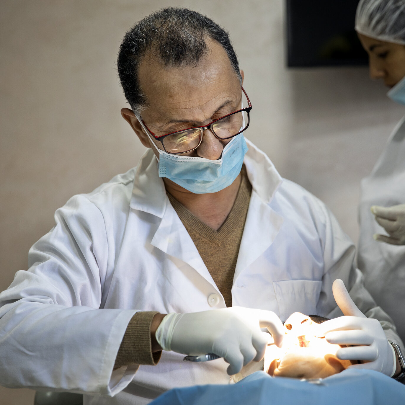 Dr. Lahcen Oussehal, Operation Smile Morocco volunteer orthodontist, examines a patient at the care center in Casablanca, Morocco.