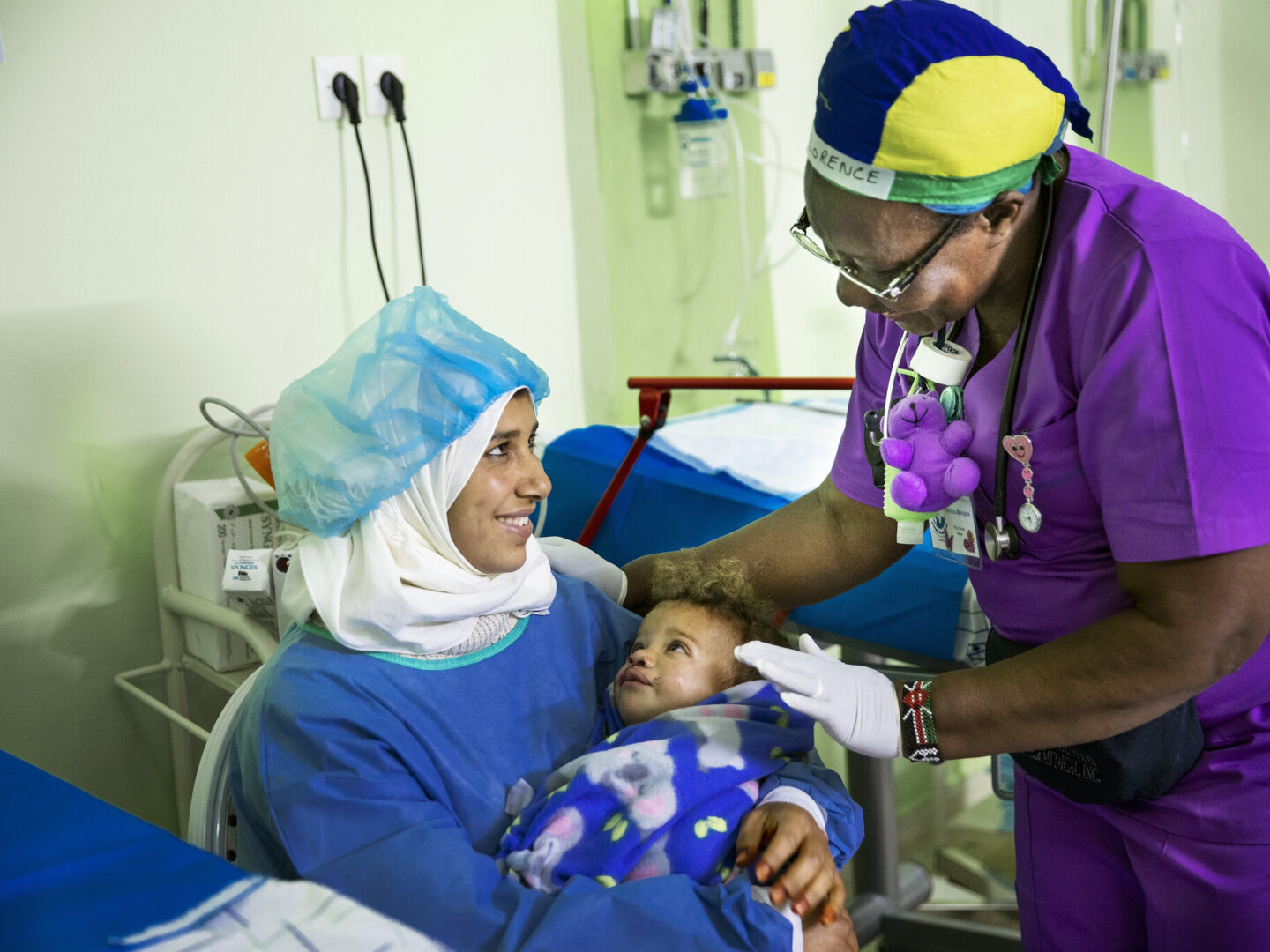 Nurse Florence Mangula speaks to a patient and mother during the 2020 Women in Medicine surgical program in Morocco.