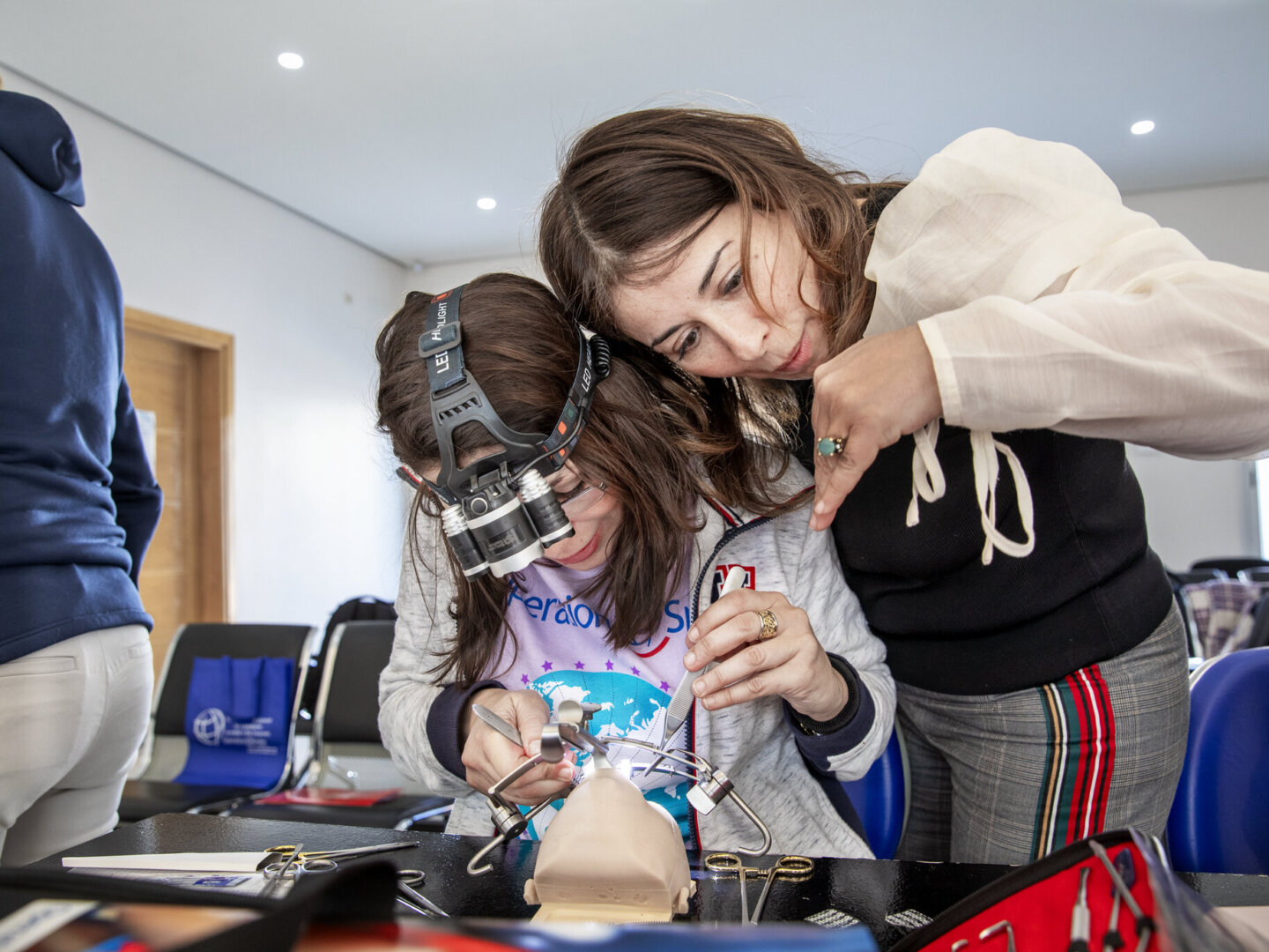 Surgeons discuss cleft repair techniques during the 2020 Women in Medicine surgical program.