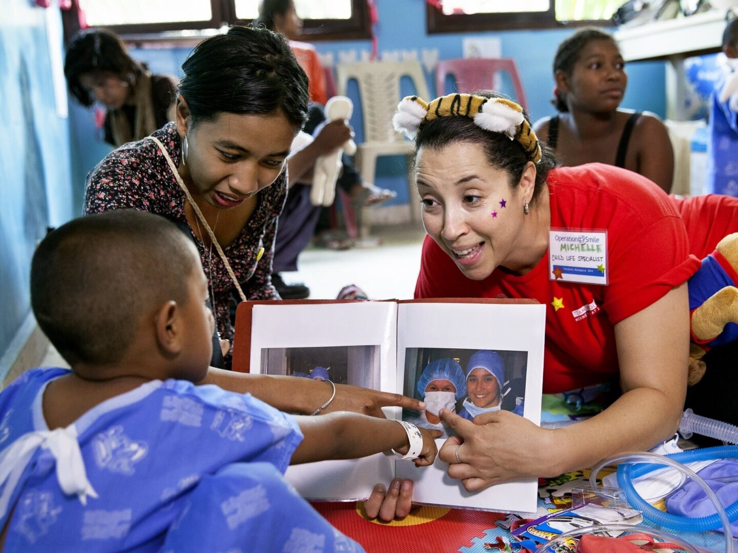 An Operation Smile volunteer discusses what to expect with a patient in Madagascar.