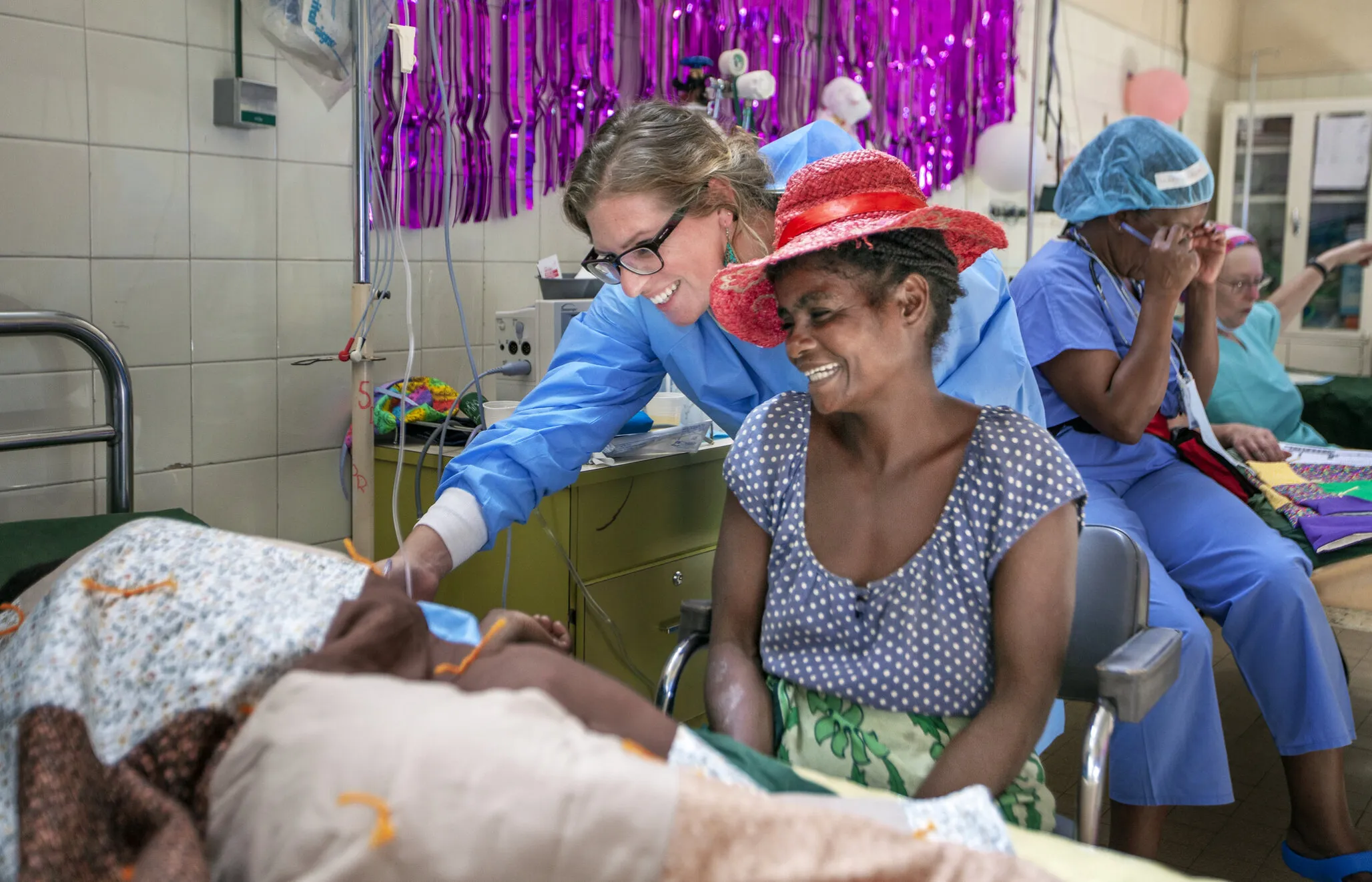 Charlotte watches as 12-year-old Frederic sees his mother, Celestine, for the first time after surgery.