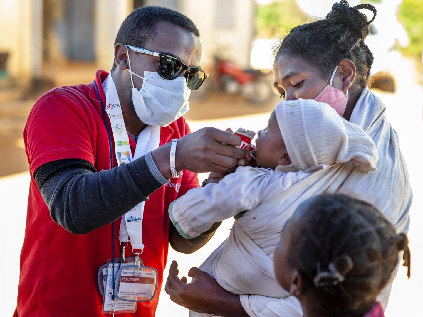 An Operation Smile volunteer provides RUTF to a patient as part of nutrition program.