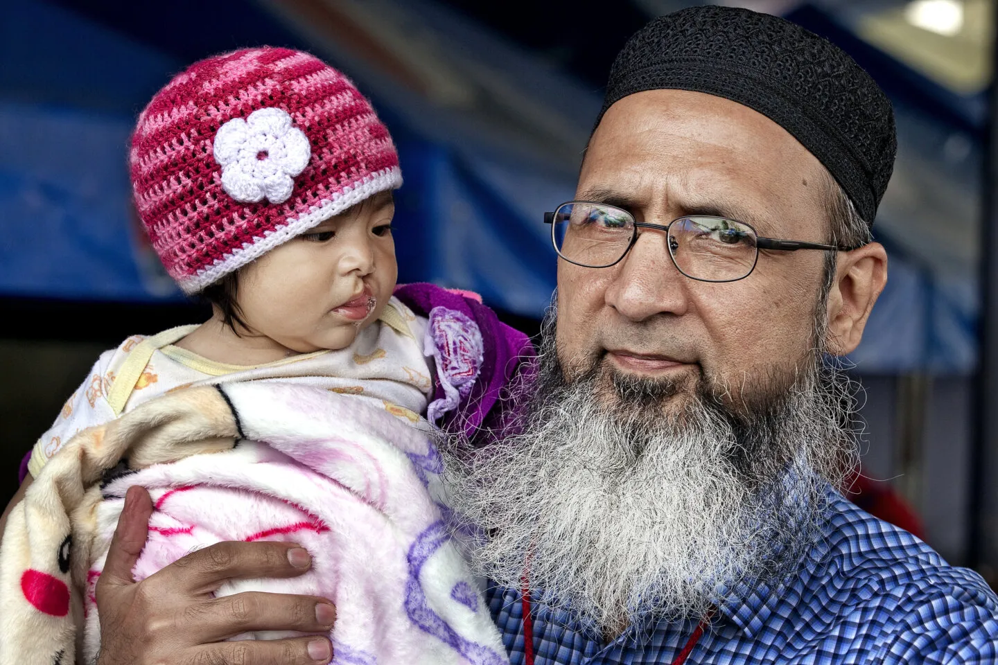 An Operation Smile volunteer and patient take a moment together.