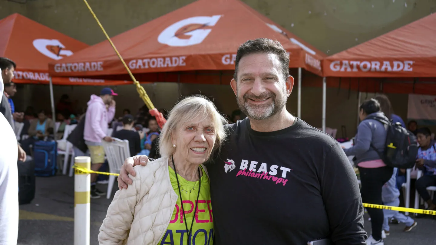 Kathy Magee stands with Beast Philanthropy staff member Darren