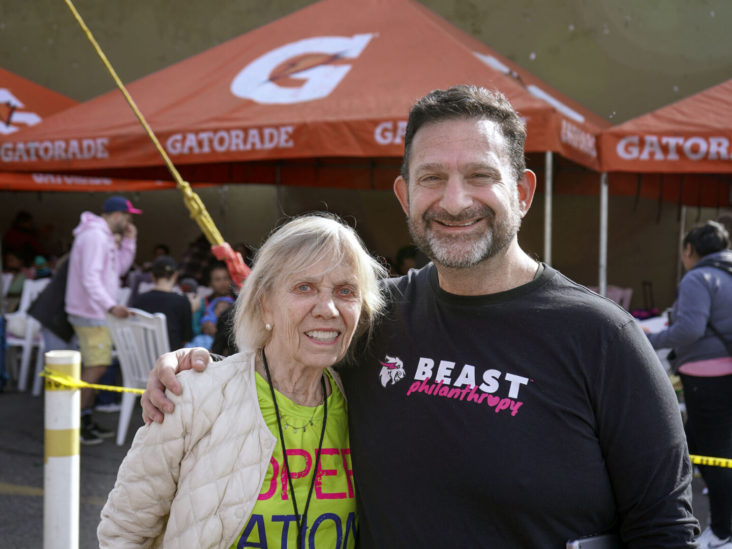 Kathy Magee stands with Beast Philanthropy staff member Darren