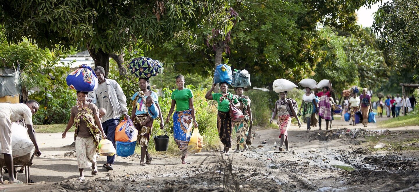 Families walk along the road in Mozambique.