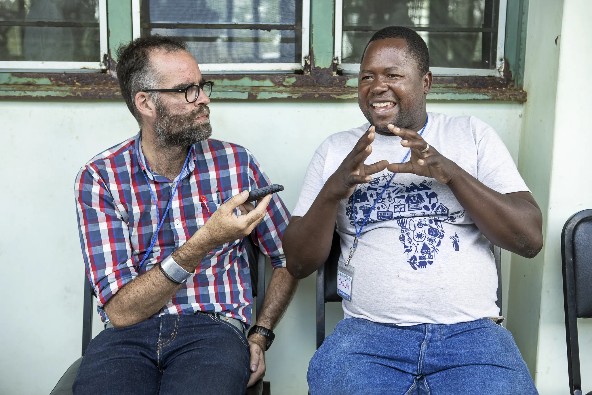 Patient coordinator Carlos Mahalambe speaks with Sean Robson of Operation Smile South Africa during the July 2018 Quelimane surgical program.