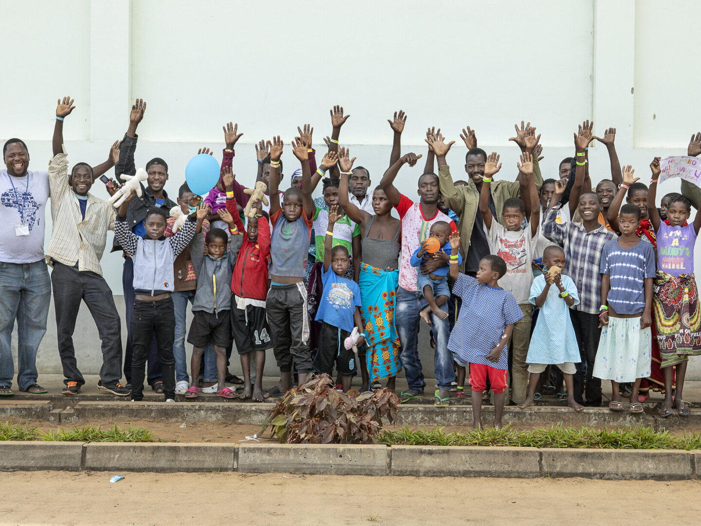 Patient coordinator Carlos Mahalambe, left, rejoices with the patients and families he accompanied to Operation Smile’s July 2018 Quelimane surgical program.