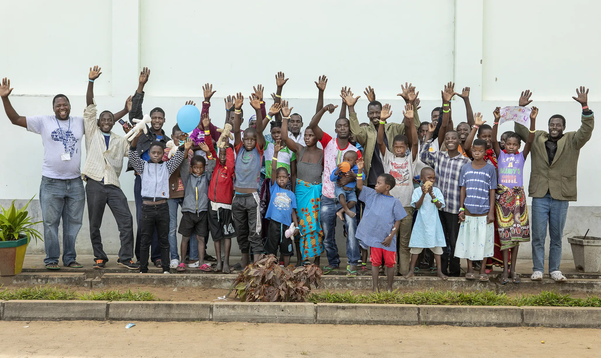Patient coordinator Carlos Mahalambe, left, rejoices with the patients and families he accompanied to Operation Smile’s July 2018 Quelimane surgical program.