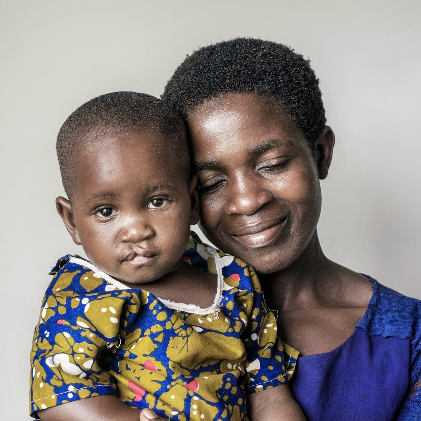 Julita snuggles with her mom before surgery.