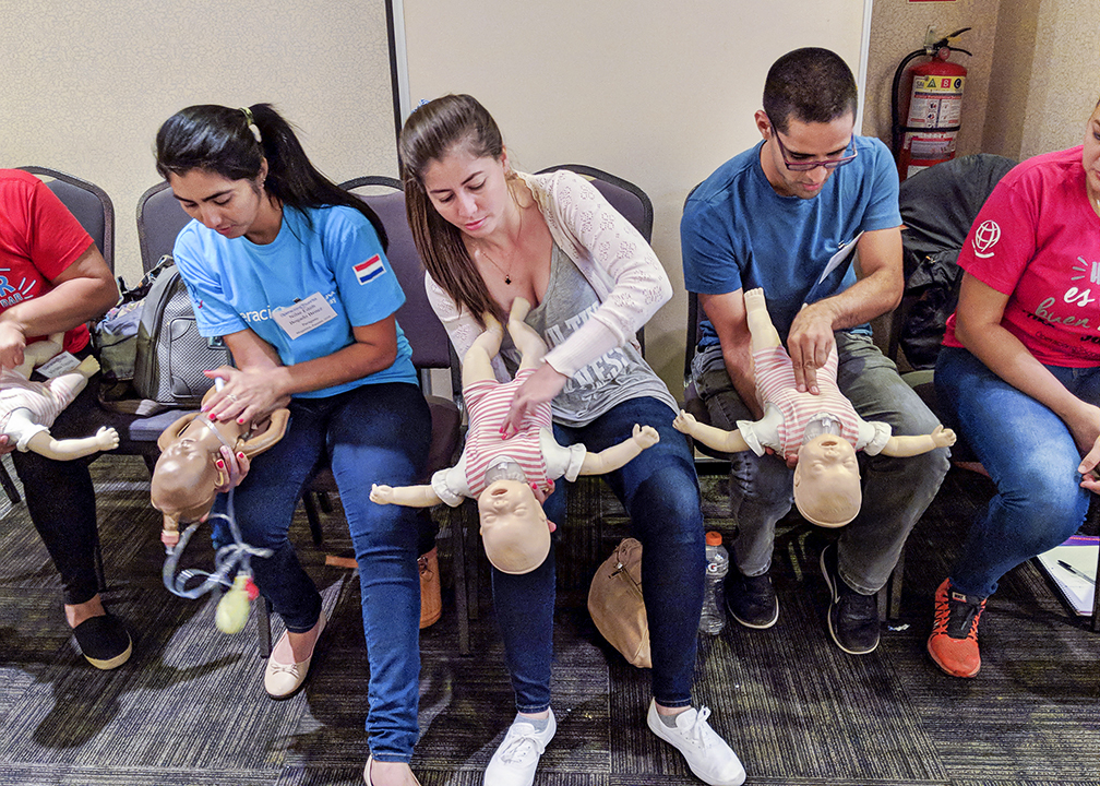 Paraguayan nurses Nilse, left, Fabiola and Luis practice saving a choking infant during a BLS course.