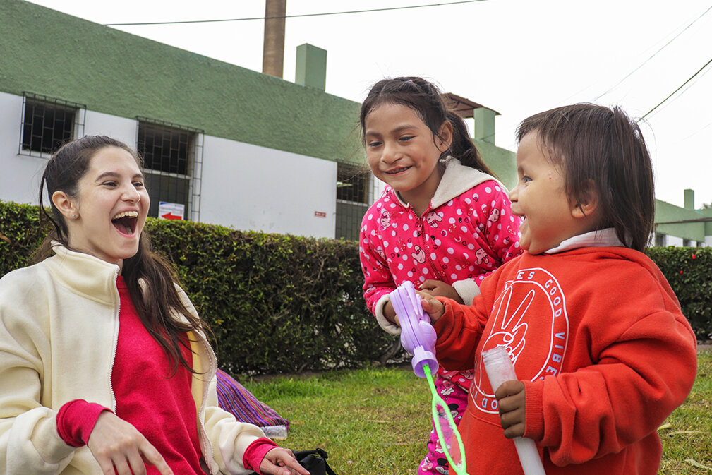 Katherine plays with children on screening day.