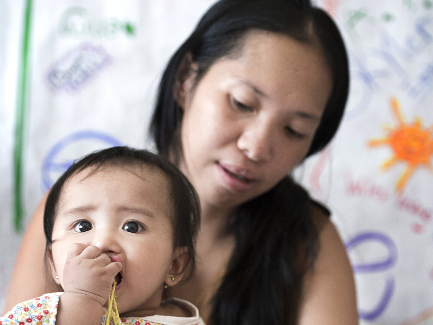 Enly chews a toy during a surgical program in the Philippines.