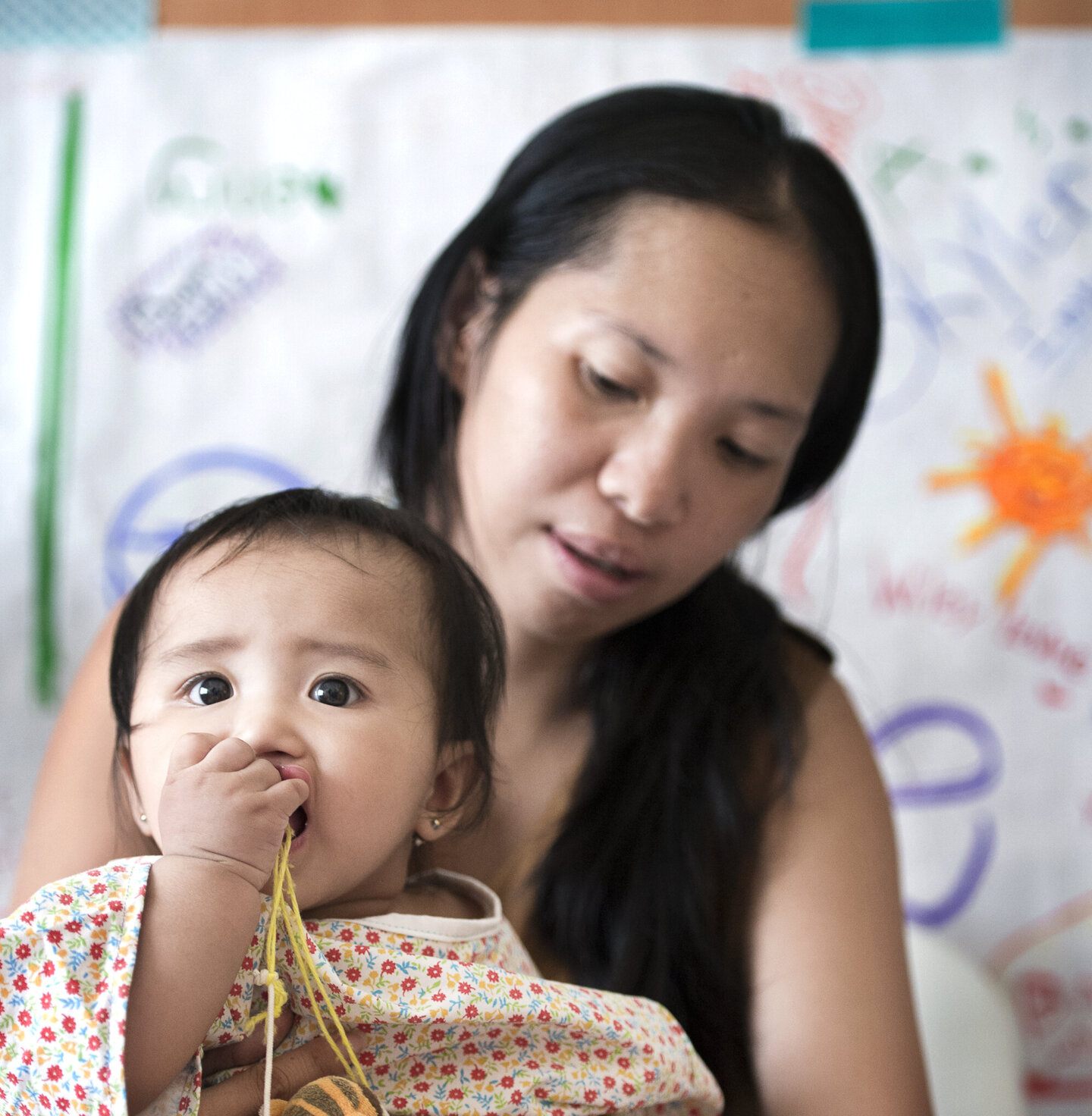 Enly chews a toy during a surgical program in the Philippines.