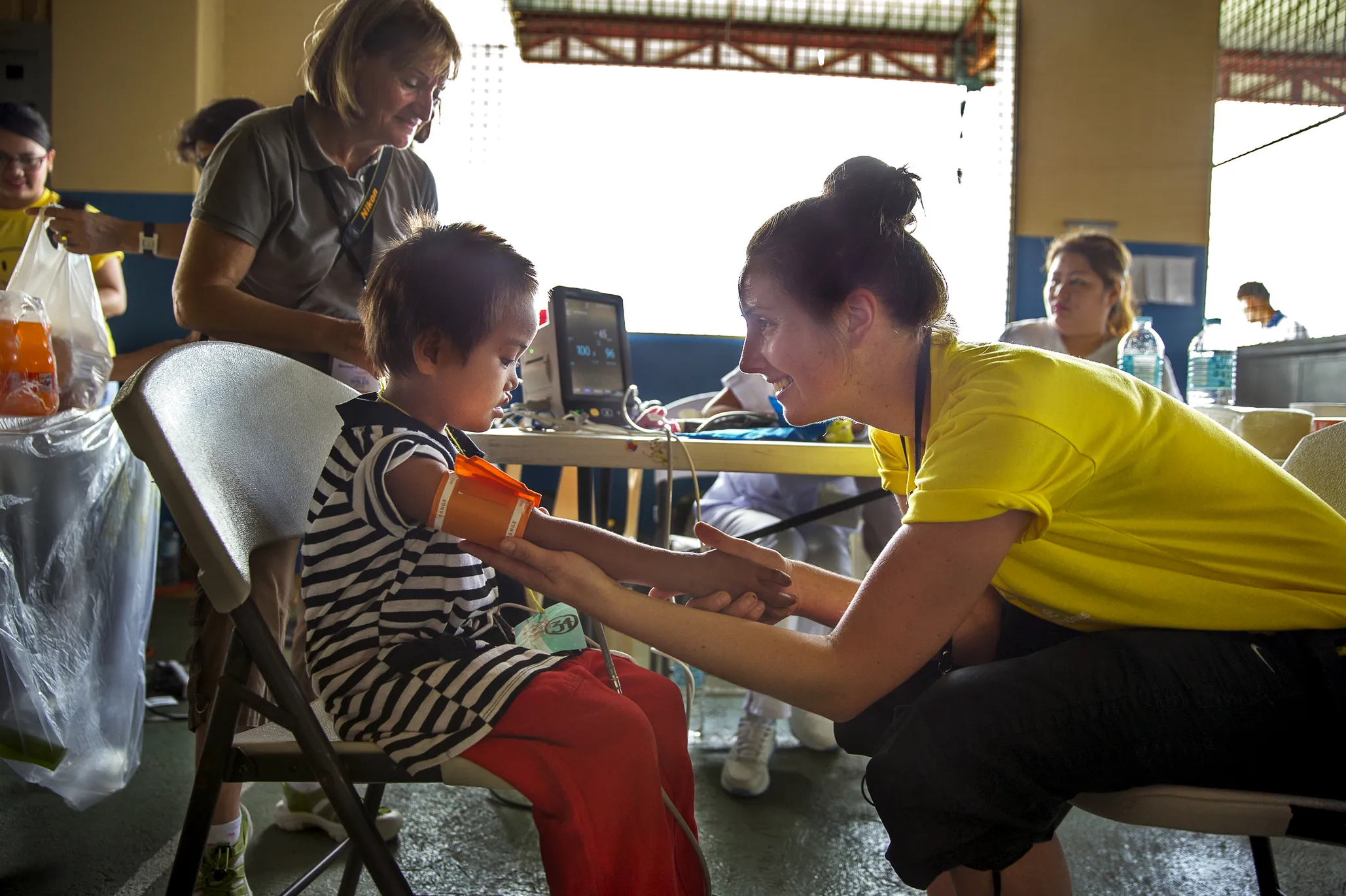 Operation Smile medical volunteers check Jane Rose's vitals during screening to ensure that she's healthy enough to undergo anesthesia for her surgery during a 2015 surgical program in Cebu.