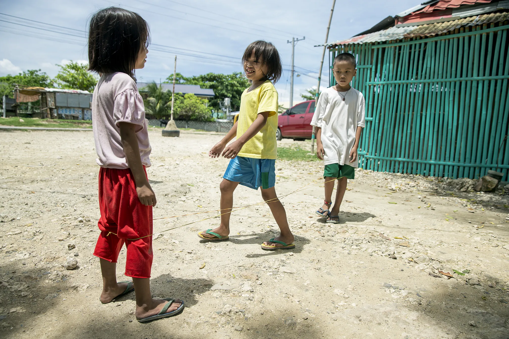 Jane Rose plays with friends at her home one year after receiving surgery from Operation Smile Philippines