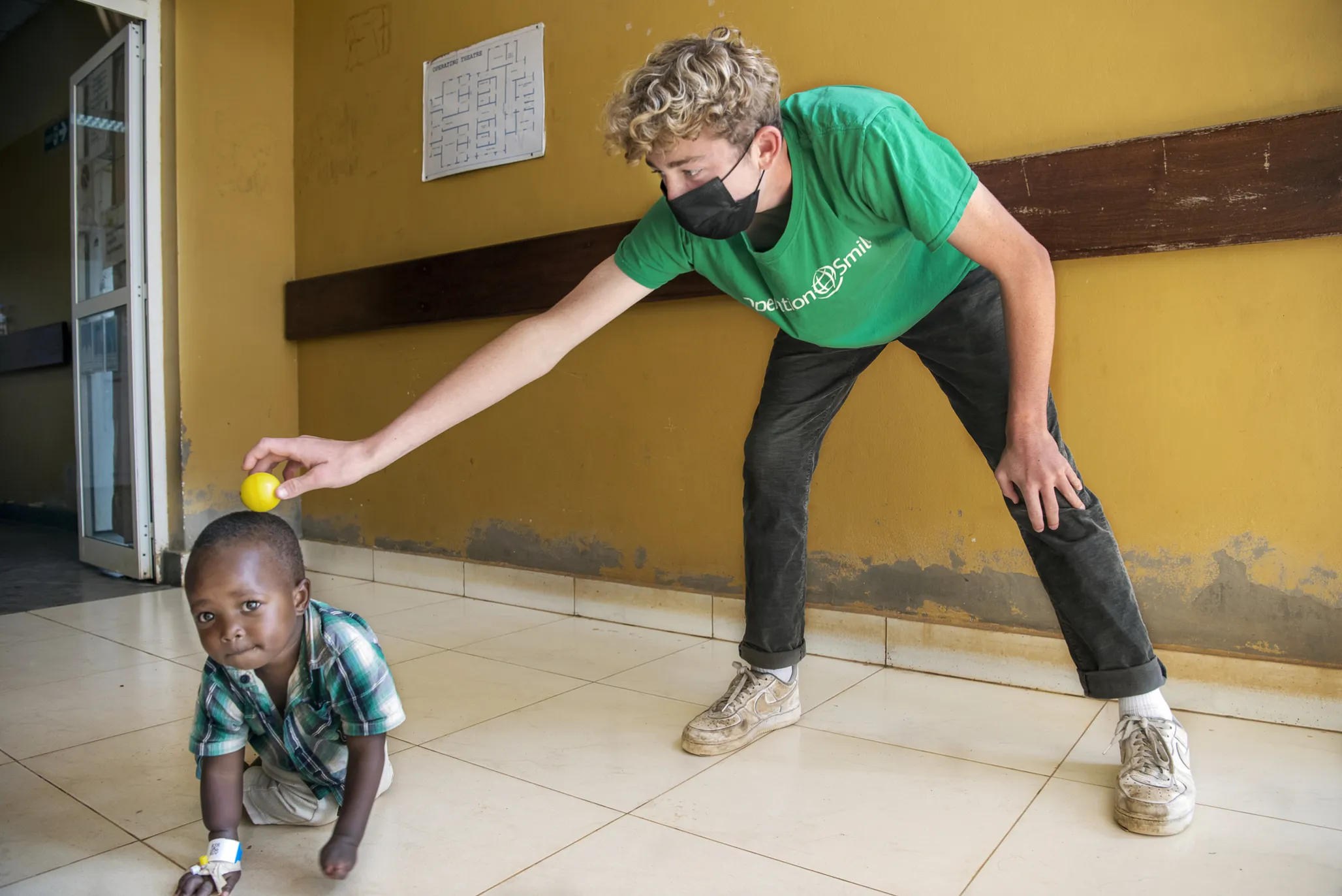 Liam Magee plays with a patient during Operation Smile Rwanda's 2022 surgical program in Bushenge.