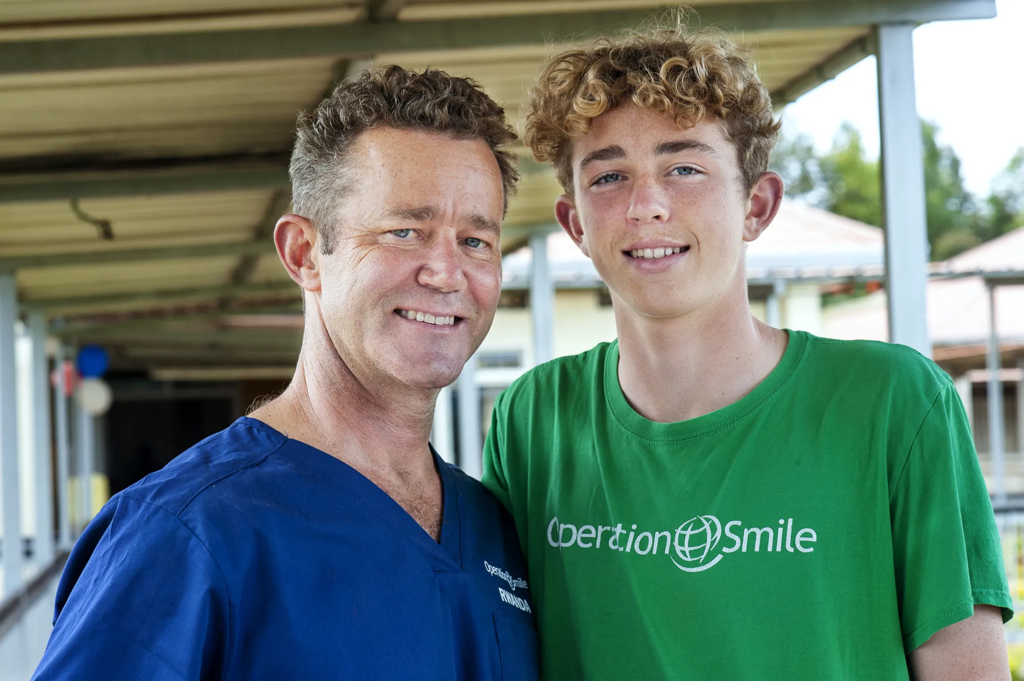 Dr. Billy Magee, left, stands beside his 14-year-old son, Liam, during a 2022 surgical program in Bushenge, Rwanda.