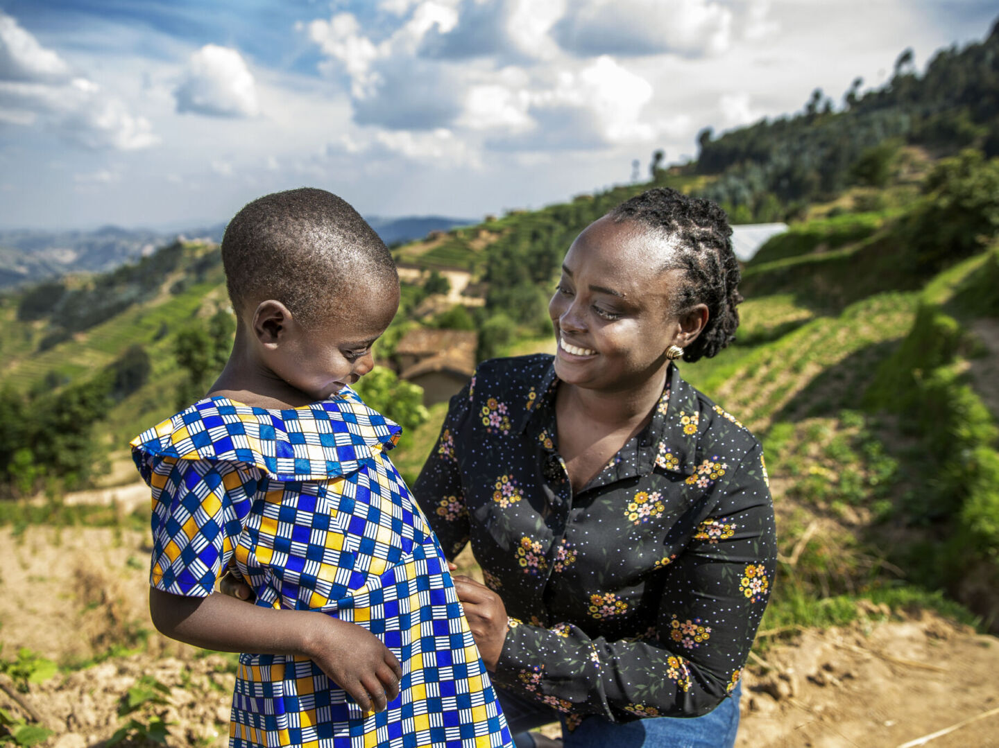 Dr. Francoise Mukagaju smiles at the camera with one of her patients, Valentine.