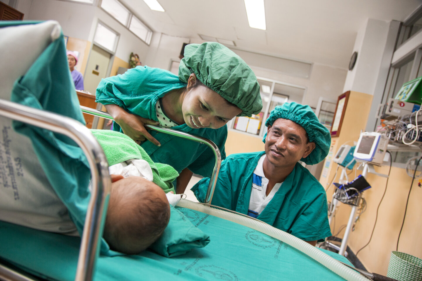 Wanna and Manus see their son Ou's smile for the first time after his cleft lip surgery. Their other twin son, Lak, also received cleft lip surgery during the same program.