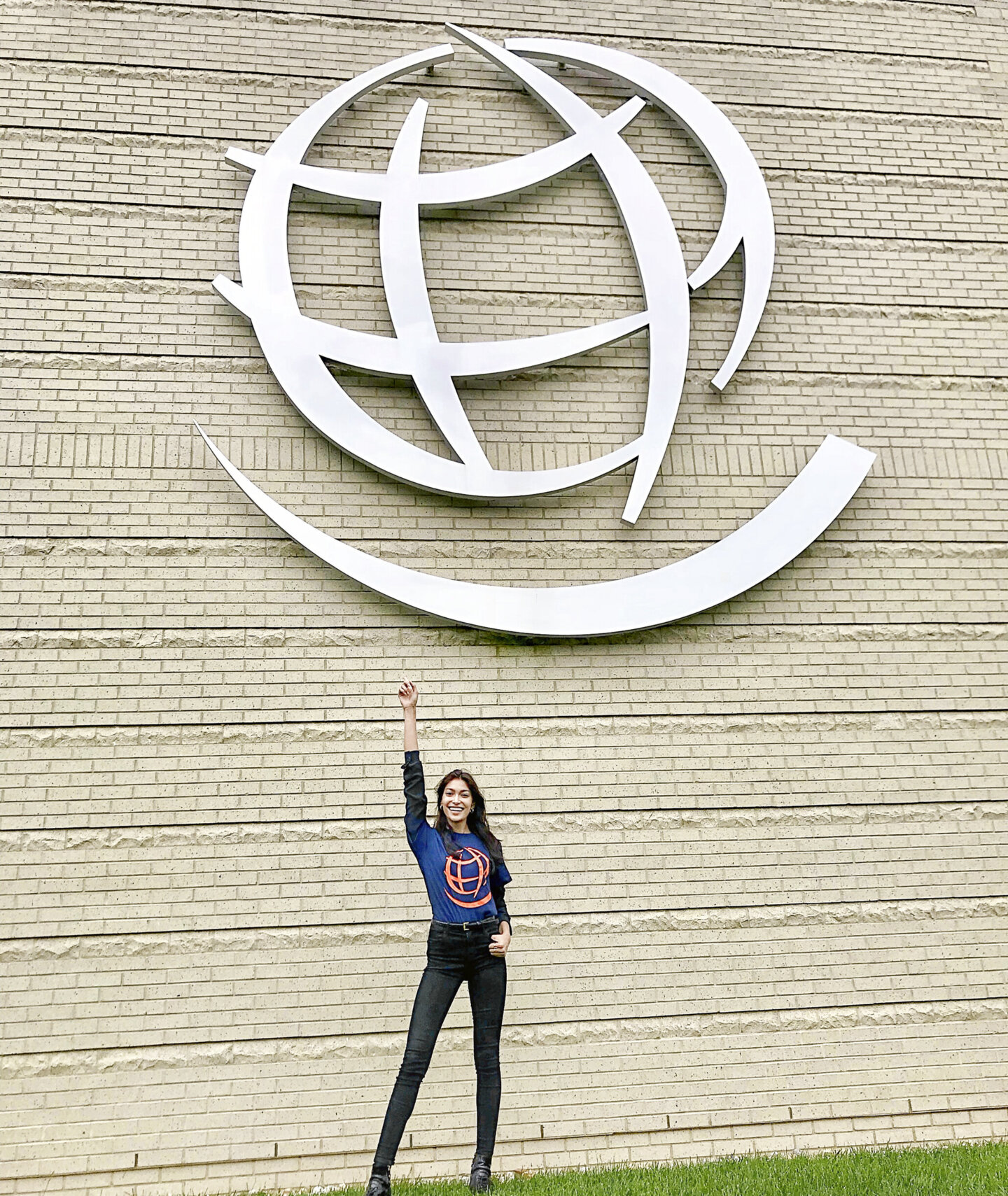 Pritika Swarup poses for a photo in front of a portion of the Operation Smile logo.