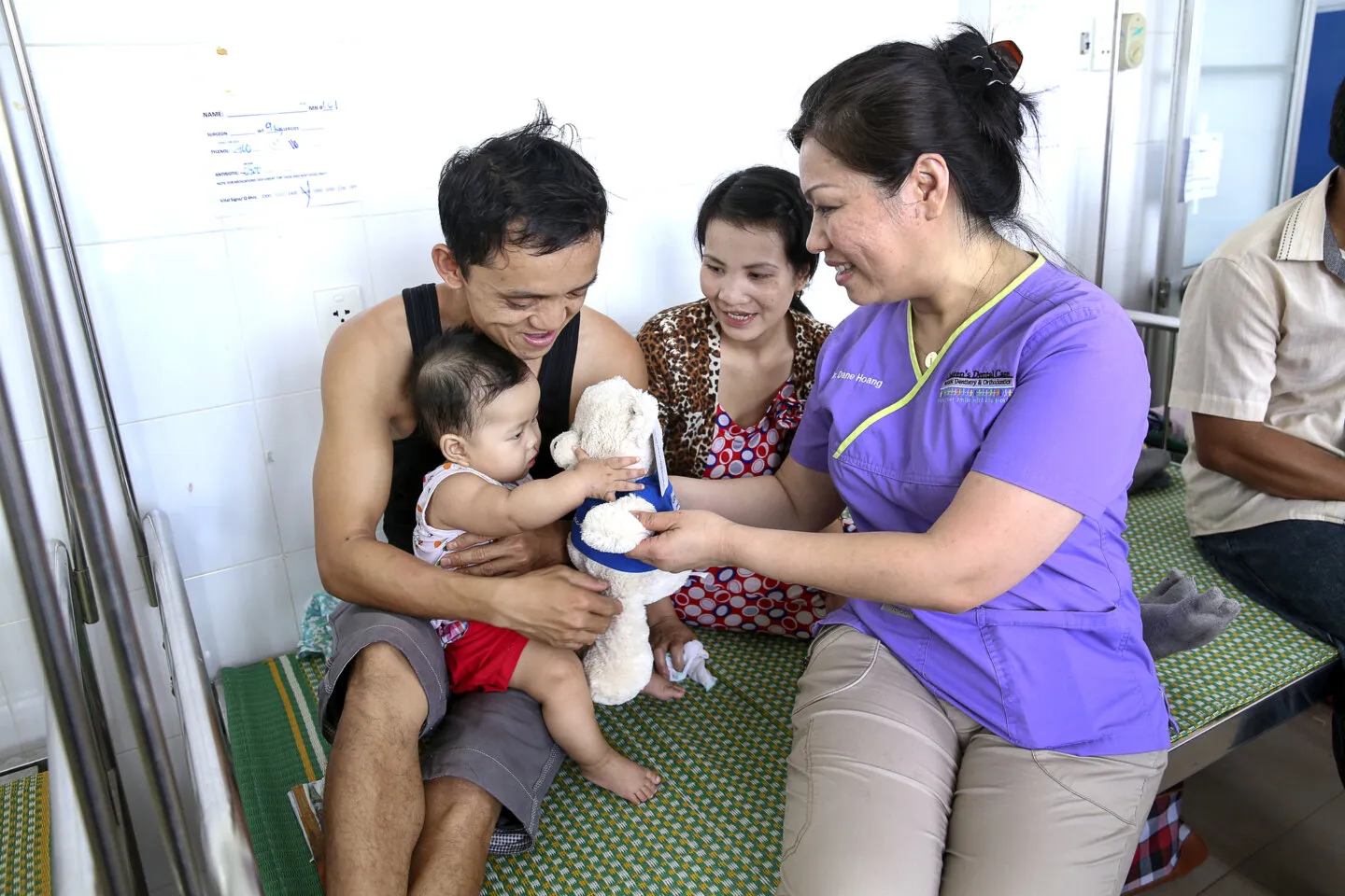 Dr. Dane Hoang plays with a young patient during the 2016 Operation Smile dental program at Hue Odonto-Stomatology Hospital in Hue, Vietnam.