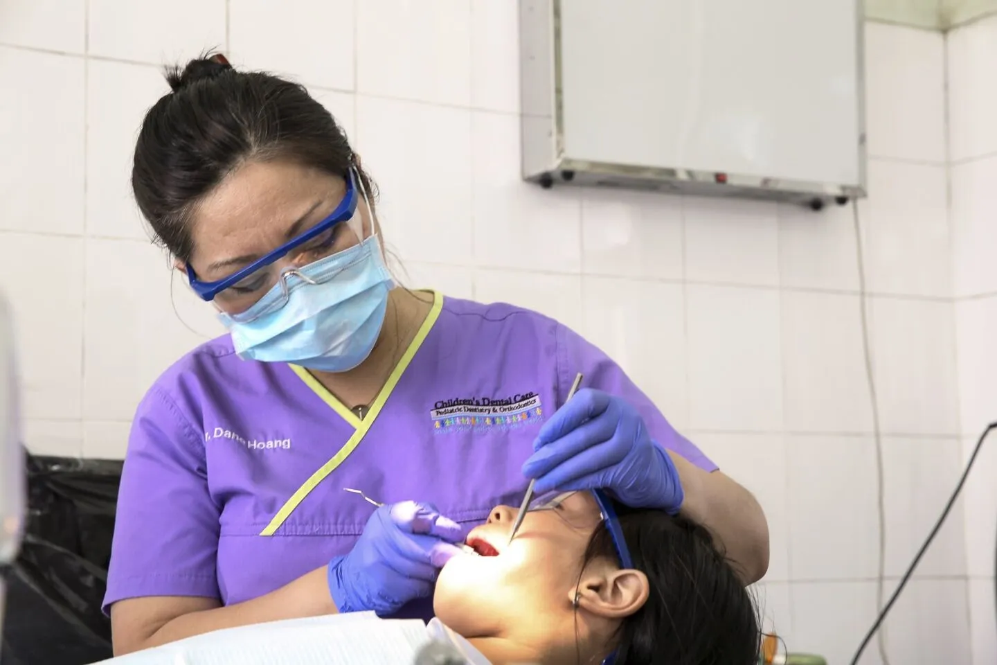 Dr. Dane Hoang provides a patient with dentistry during the 2016 Operation Smile dental program at Hue Odonto-Stomatology Hospital in Hue, Vietnam.