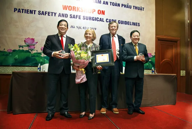 Associate Professor Dr. Luong Ngoc Khue, left, Director of Medical Services Administration Department of Vietnam's Ministry of Health; Kathy Magee, right, Operation Smile Co-Founder; Dr. Bill Magee, Operation Smile Co-Founder; and Professor Dr. Nguyen Viet Tien, Vice Minister of Vietnam's Ministry of Health, pose together for a photo.
