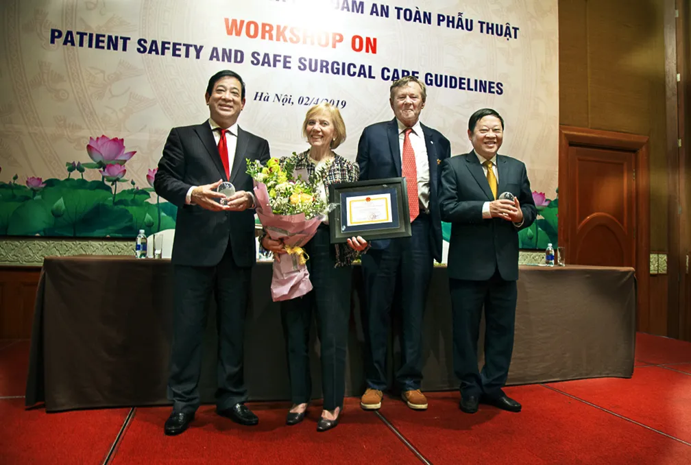 Associate Professor Dr. Luong Ngoc Khue, left, Director of Medical Services Administration Department of Vietnam's Ministry of Health; Kathy Magee, right, Operation Smile Co-Founder; Dr. Bill Magee, Operation Smile Co-Founder; and Professor Dr. Nguyen Viet Tien, Vice Minister of Vietnam's Ministry of Health, pose together for a photo.