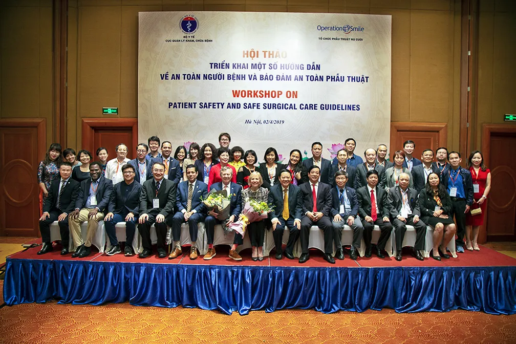 Representatives from Operation Smile, Vietnam's Ministry of Health, Medical Services Administration and affiliated global health partners pose for a photo during the conference in Vietnam.