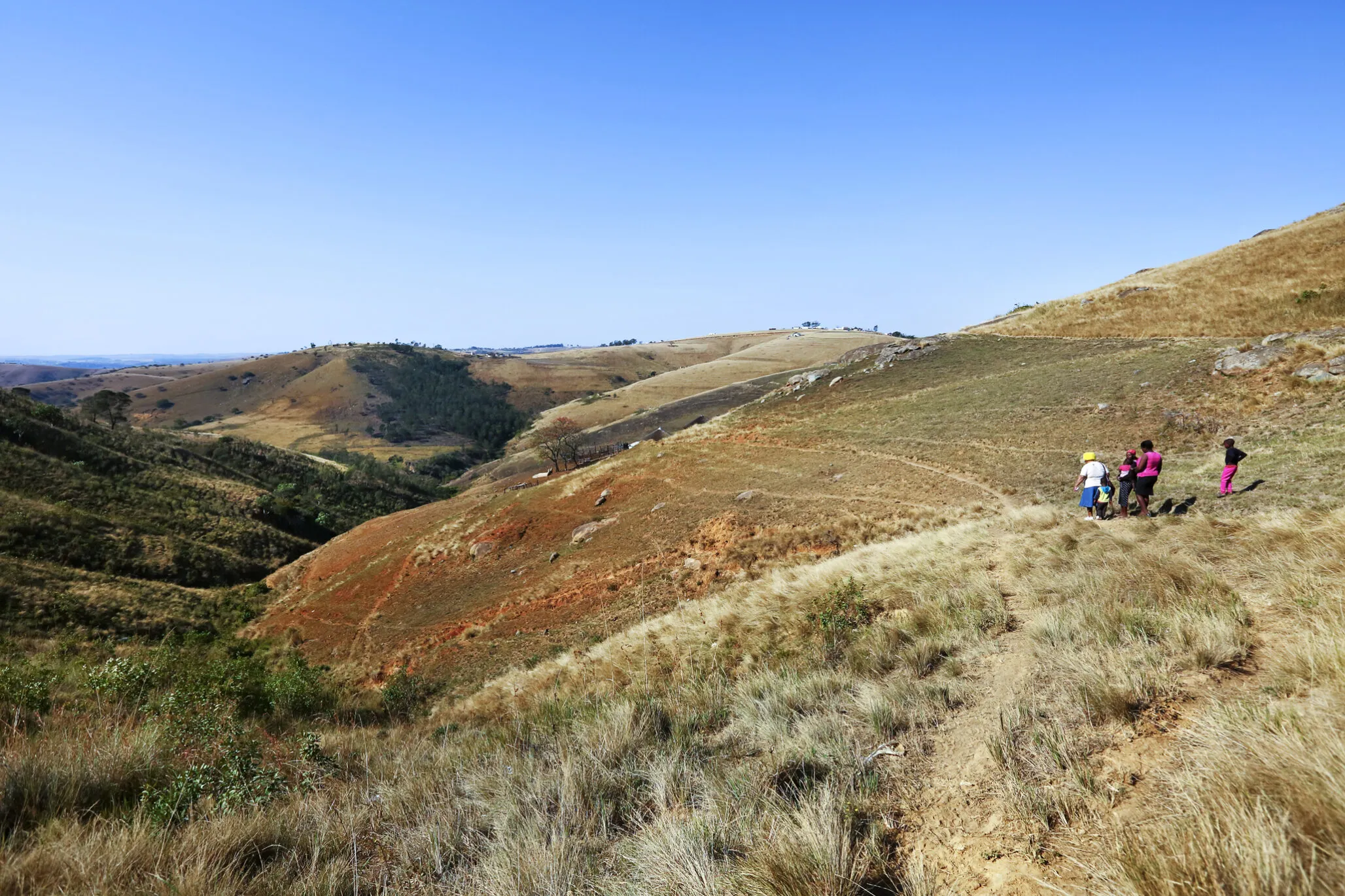 Nurse Funeka Cele and others traverse the landscape in South Africa.