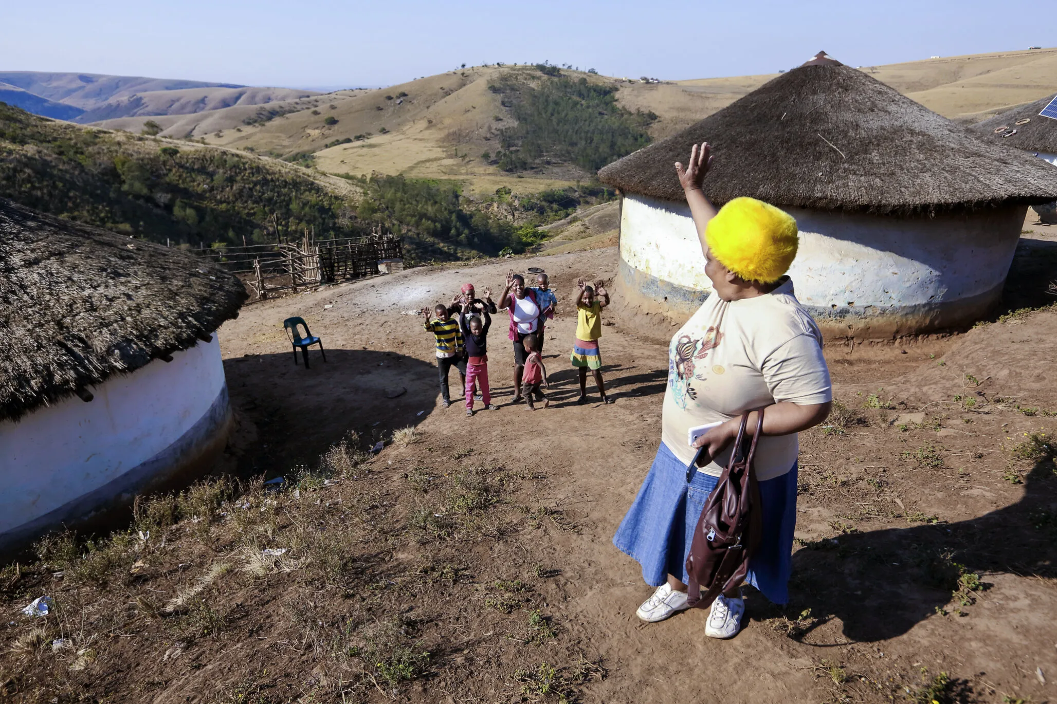 Nurse Funeka Cele waves to families.