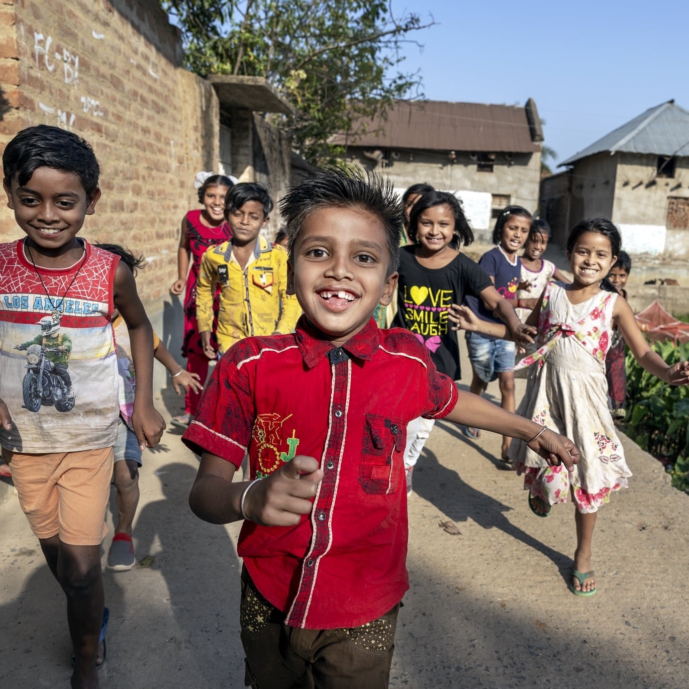 Shyam runs towards the camera with friends.