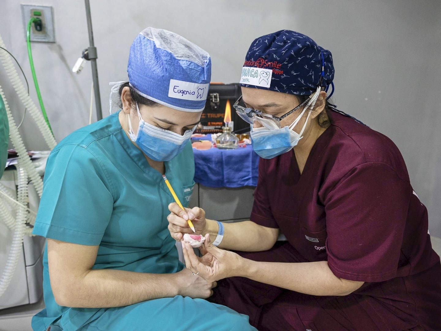 Volunteer dentist Dr. Monica De Leon of Guatemala, right, mentors fellow dentist Dr. Eugenia Azmitia of Guatemala about the specifics of creating obturators, which help patients born with cleft palate to feed.