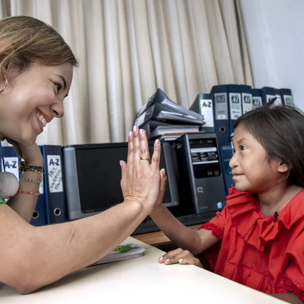 Lexxi works with a speech language pathologist during a program in Colombia.