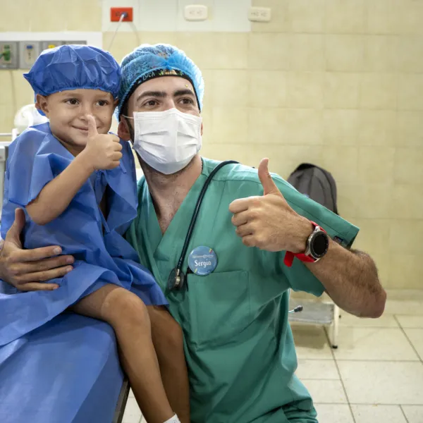 An anesthesiologist poses with his patient during a surgical program in Colombia.