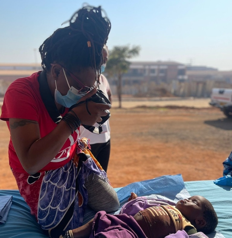 Dee Dingalo takes a photo of a patient during a surgical program.