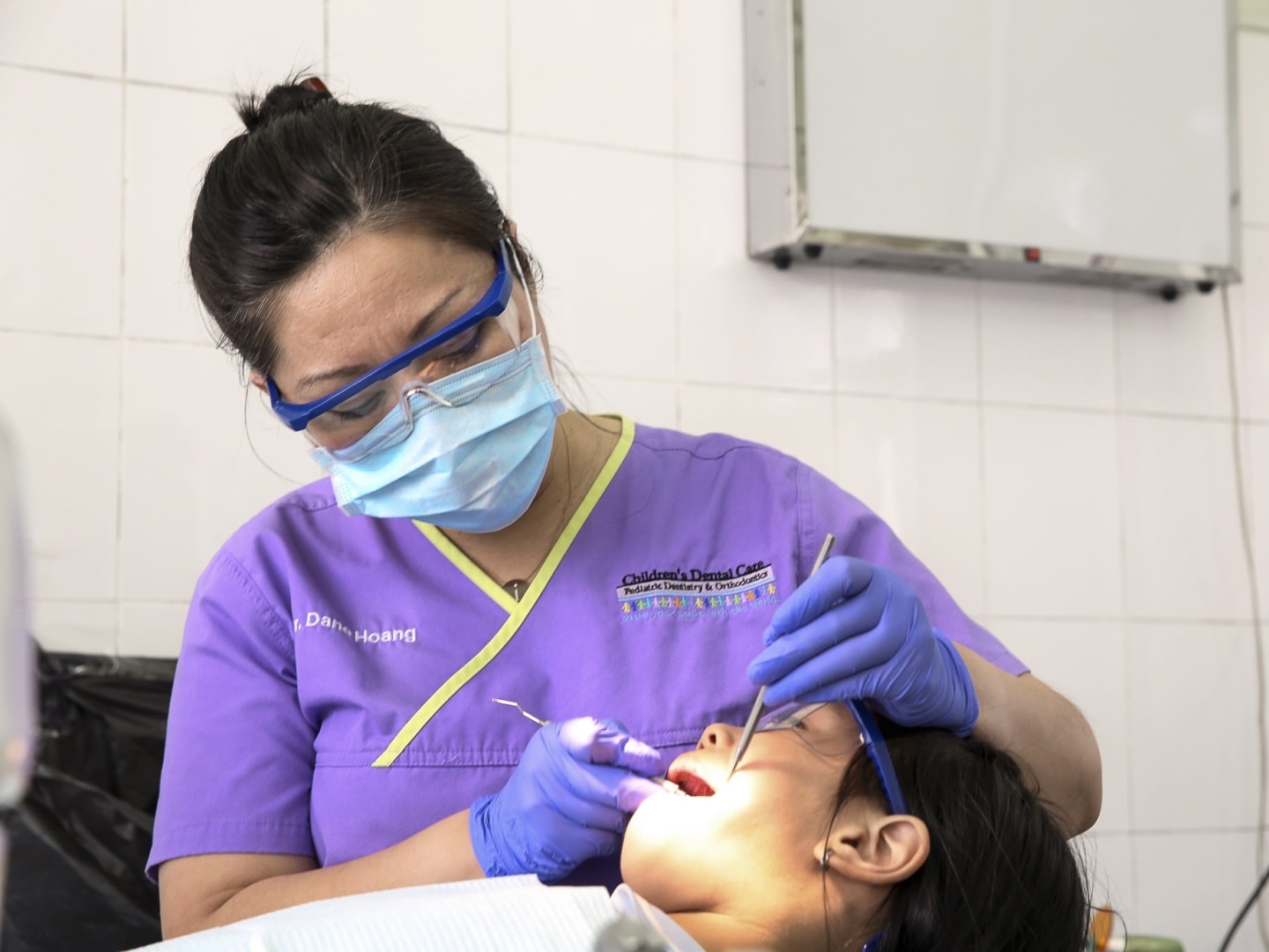 Dr. Dane Hoang provides a patient with dentistry during the 2016 Operation Smile dental program at Hue Odonto-Stomatology Hospital in Hue, Vietnam.