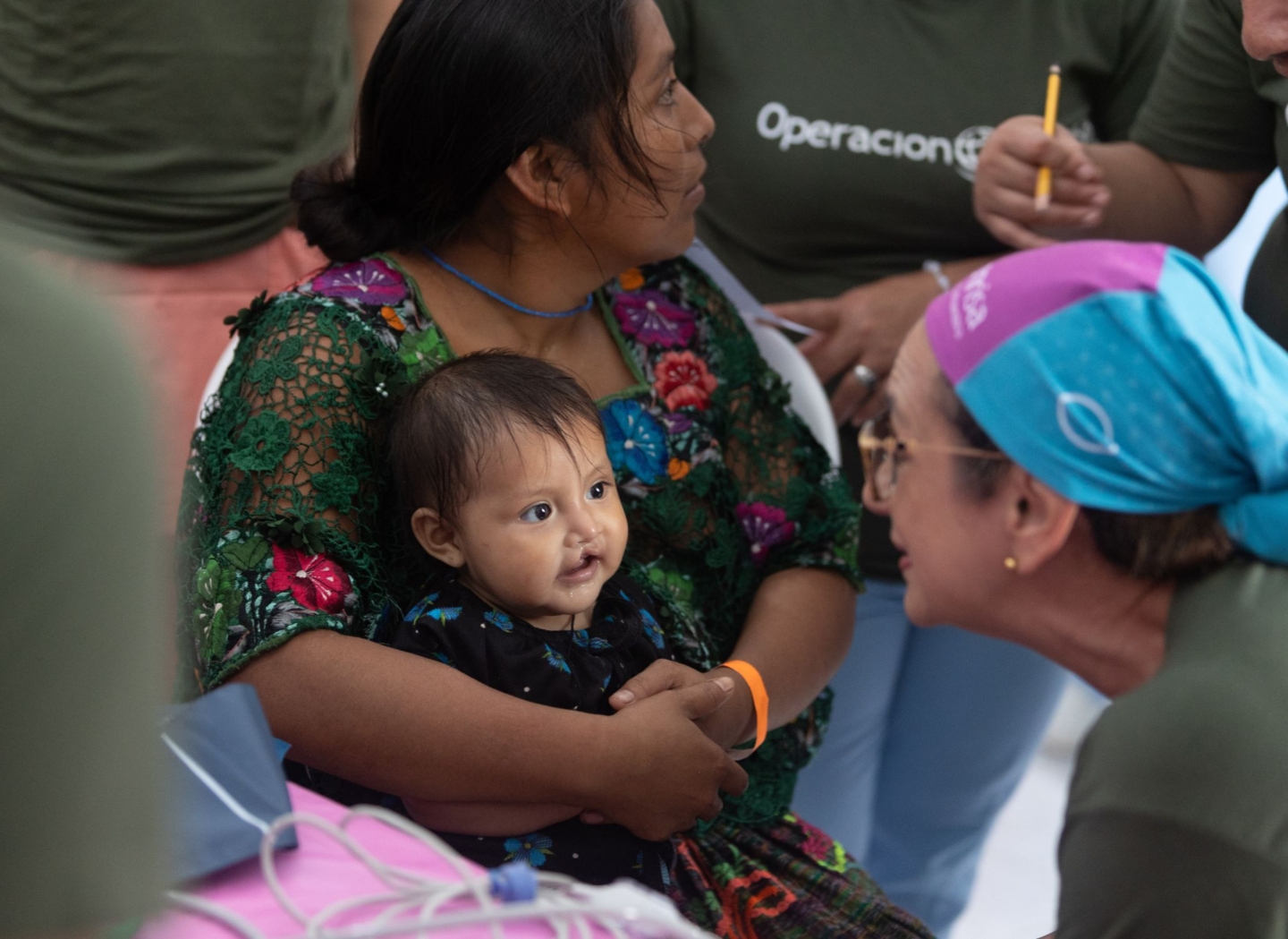 A volunteer entertains Melinda during a surgical program in Guatemala.