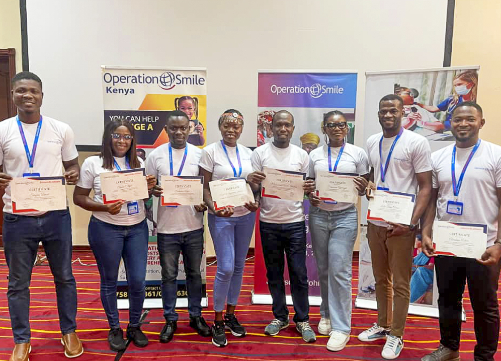 Nurses show their certificates after a training program in Kenya.