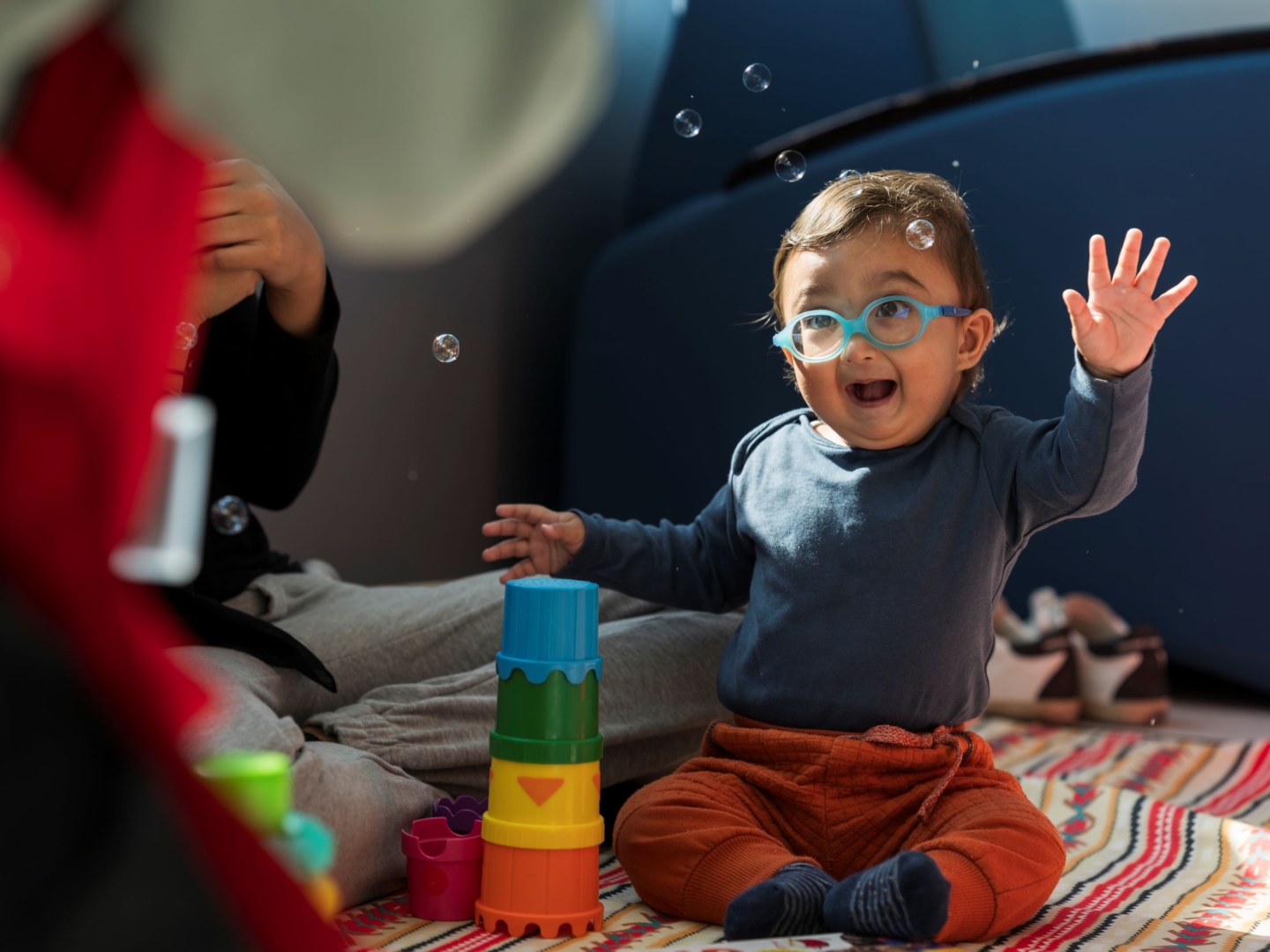 Zain plays with bubbles at an Operation Smile program.