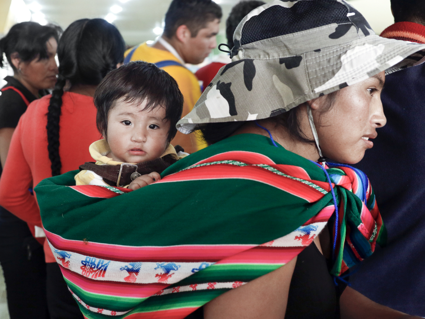 Andy, held by his mother, attends a program in Santa Cruz, Bolivia.